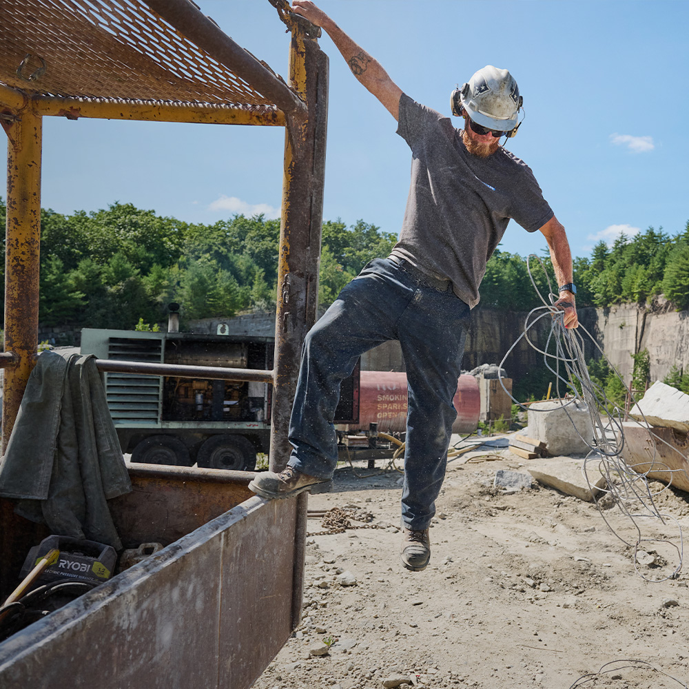 A man wearing Carolina boots on a job site.