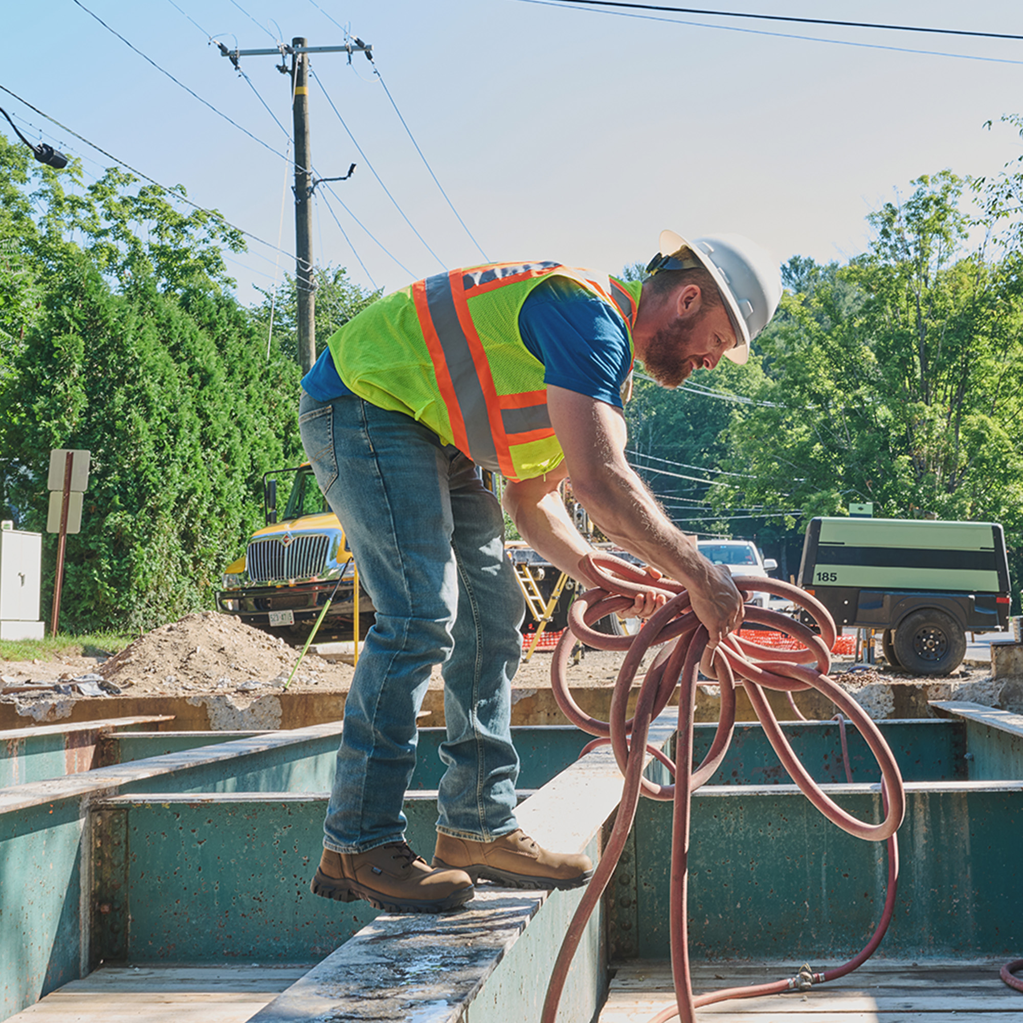 A man wearing Carolina boots on a job site.
