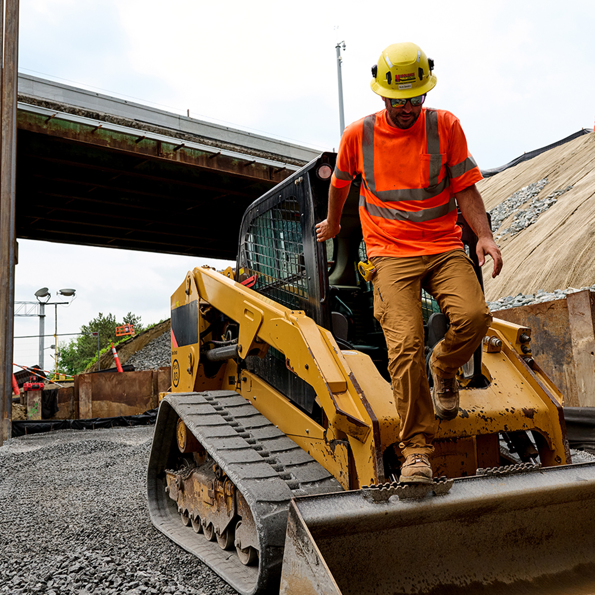 A man wearing Carolina shoes on a job site.