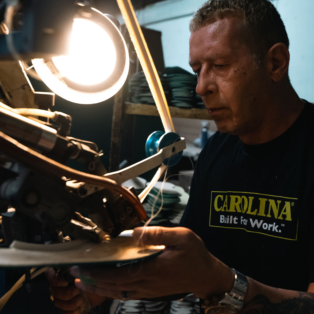 A factory worker making a Carolina boot.