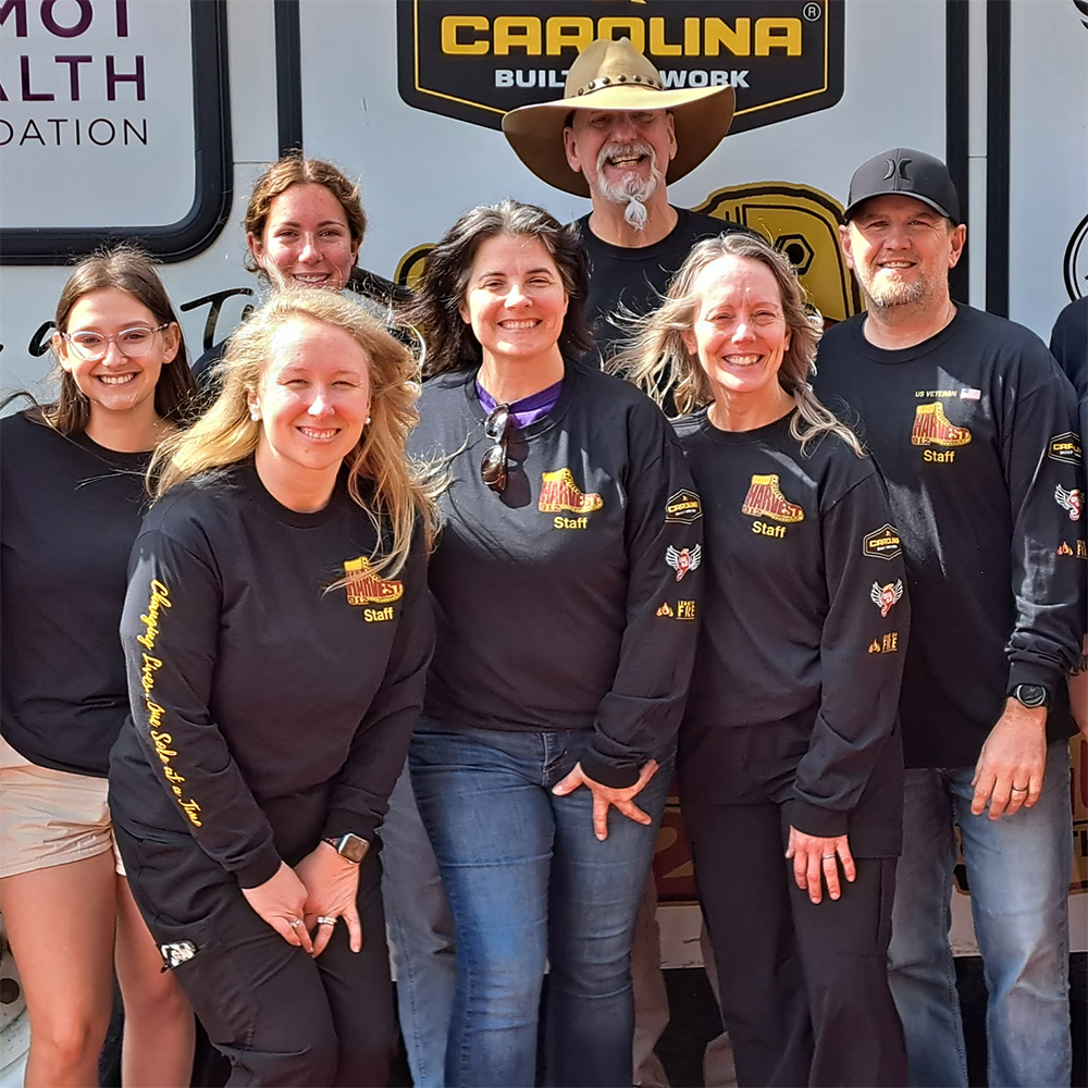A group of volunteers standing in front of a the van.