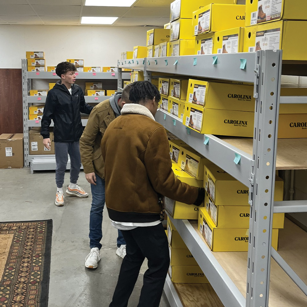 Volunteers pulling Carolina boot boxes off shelves.